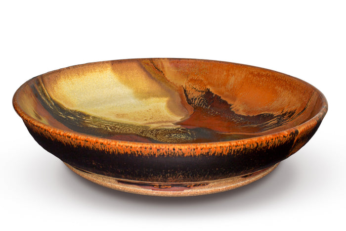 12 inch stoneware bowl in beautiful earth tone colors and red. Handmade pottery by Prairie Fire Pottery. Wheel-thrown and high=fired to 2400°. Made in the U.S.A.  This is the side view showing shape and depth.