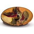 Beautiful handmade pottery bowl in earth tone colors accented with red.  Handmade pottery by Prairie Fire Pottery.  Made in the U.S.A.  Stoneware clay high-fired to 2400°.  3/4 view.