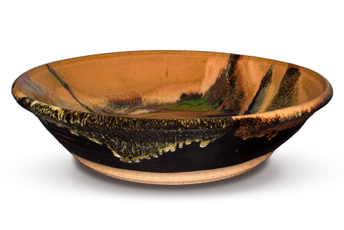 13 inch wheel-thrown stoneware bowl accented with vibrant red, green, and purple-blue colors.  Handmade pottery by Prairie Fire Pottery.  Side view.
