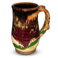 18 ounce wheel-thrown stoneware mug.  Gorgeous glaze colors, toasted orange, earth tones, and red.  Handmade pottery by Prairie Fire Pottery.  Right side view.