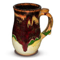 18 ounce wheel-thrown stoneware mug.  Very pretty glaze colors, toasted orange, earth tones, and red.  Handmade pottery by Prairie Fire Pottery.  Right side view.
