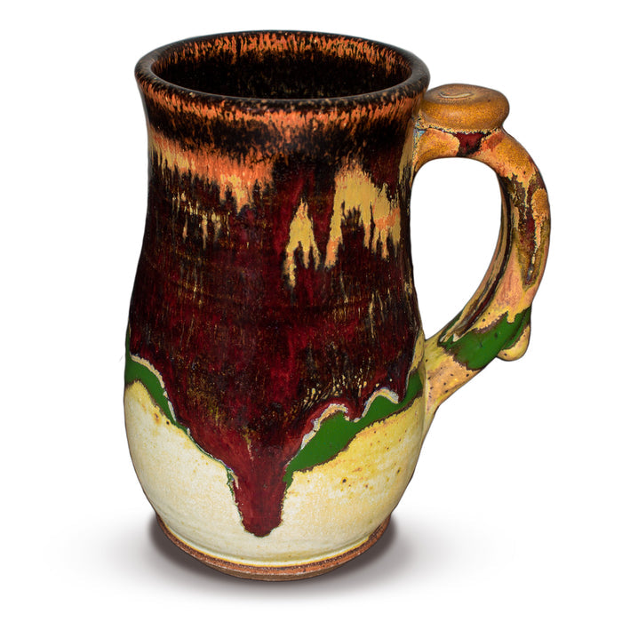 18 ounce wheel-thrown stoneware mug.  Very pretty glaze colors, toasted orange, earth tones, and red.  Handmade pottery by Prairie Fire Pottery.  Right side view.