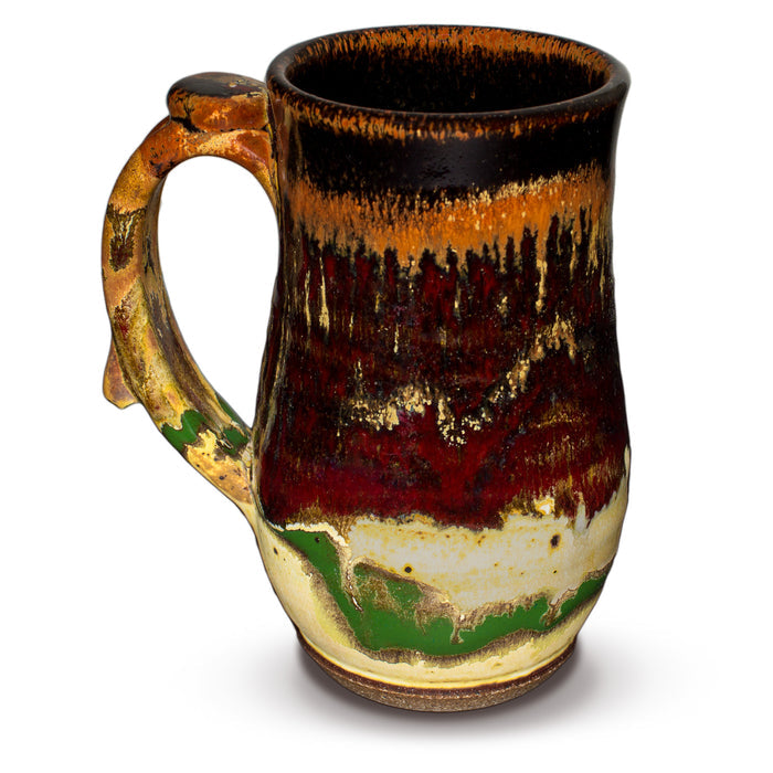 18 ounce wheel-thrown stoneware mug.  Gorgeous glaze colors, toasted orange, earth tones, and red.  Handmade pottery by Prairie Fire Pottery.  Left side view.
