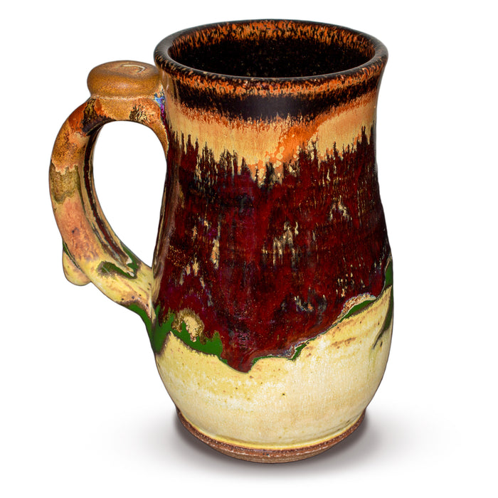 18 ounce wheel-thrown stoneware mug.  Very pretty glaze colors, toasted orange, earth tones, and red.  Handmade pottery by Prairie Fire Pottery.  Left side view.
