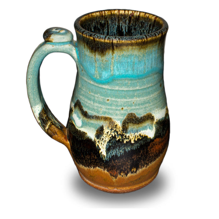 Handmde 20 ounce pottery mug.  Turquoise and brown colors.  Hand made by Prairie Fire Pottery.  Left side view.