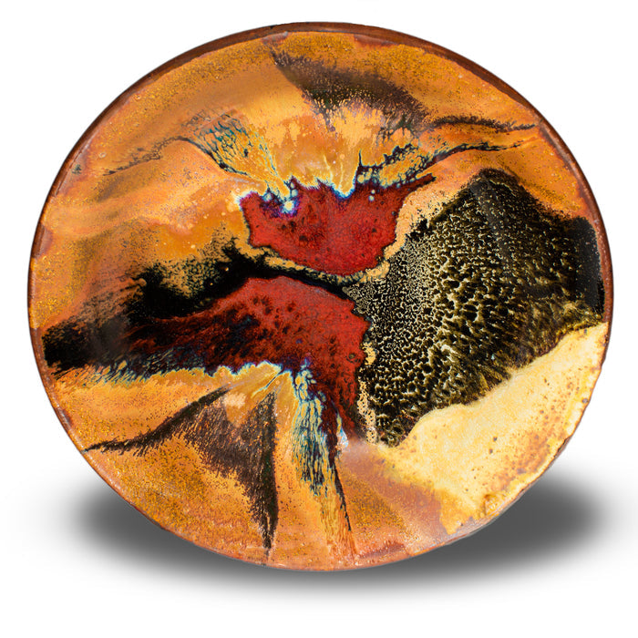 Wheel-thrown stoneware bowl in earth tone colors accented with red. Handmade pottery, Made in the U.S.A. by Prairie Fire Pottery. Overhead view of bowl.