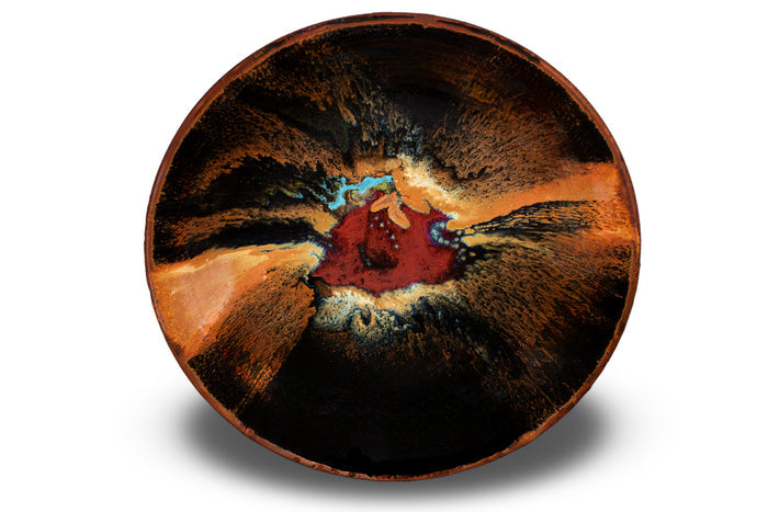 This is a beautiful 9 inch stoneware bowl in rich toasted brown and black colors accented with red. Handmade pottery fired to 2400° by Prairie Fire Pottery. This is an overhead view of the bowl.