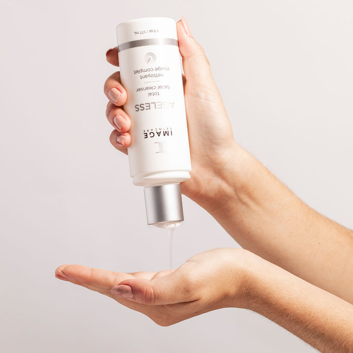 Person dispensing IMAGE Skincare Ageless Total Facial Cleanser - glycolic acid cleanser for youthful, radiant skin