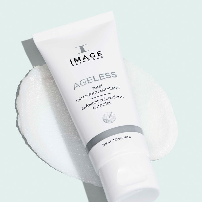 microderm exfoliator bottle laying on texture swatch on light background