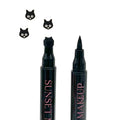 Two black Sunset Makeup cat stamp eyeliner applicators displayed on a white background with a black cat stamp impression.