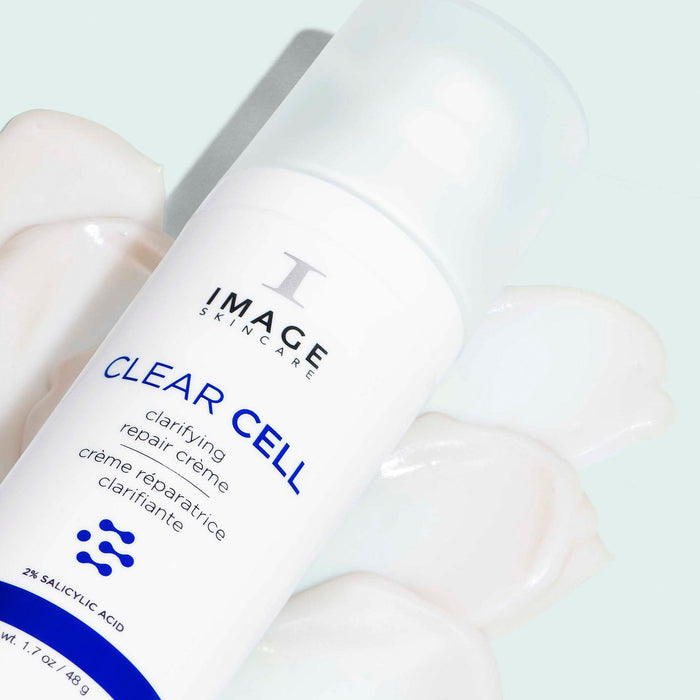 CLEAR CELL clarifying repair crème bottle laying on texture swatch