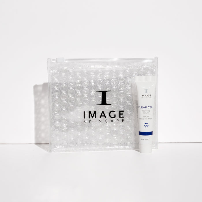 Clear cell restoring serum travel size next to clear bubble bag