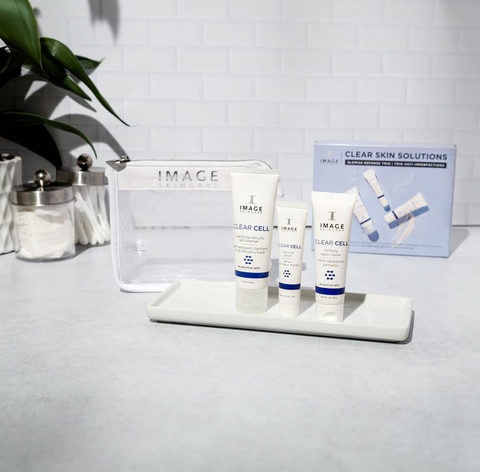 3 kit products on bathroom counter with white mesh bag and kit box behind products