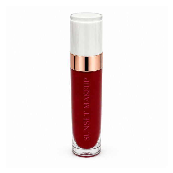 Sunset Makeup liquid lipstick in a clear glass tube showing a deep berry red shade, with a metallic rose gold collar and a white cap, on a white background.