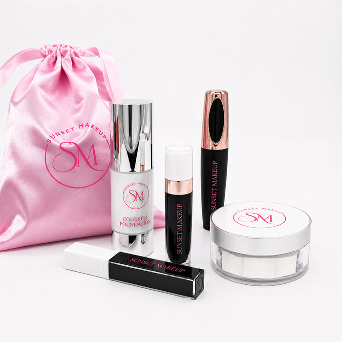 Sunset Makeup cosmetic set on a white background, including a pink satin drawstring bag, White Colorful Foundation, Black Matte Liquid Lipstick #39 “Existence", White Colorful Mascara #10, Six Feet Below Black Lip Gloss, and Setting Powder #9 White.