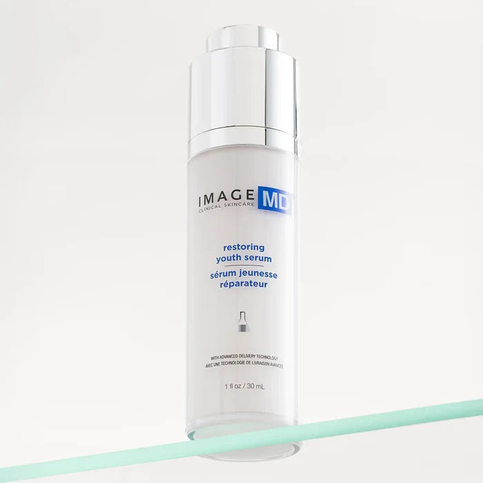 Skincare serum bottle labeled 'Image Skincare restoring youth serum' on a white background