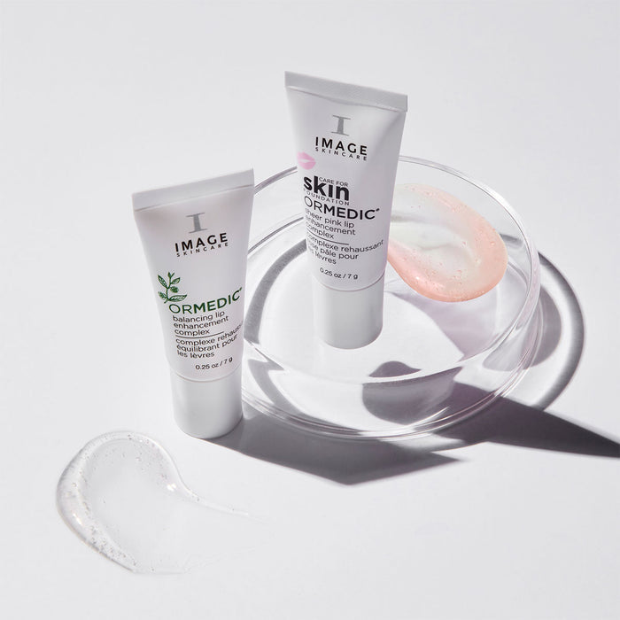 ormedic lip complex and sheer pink lip complex with texture shots of both on white background
