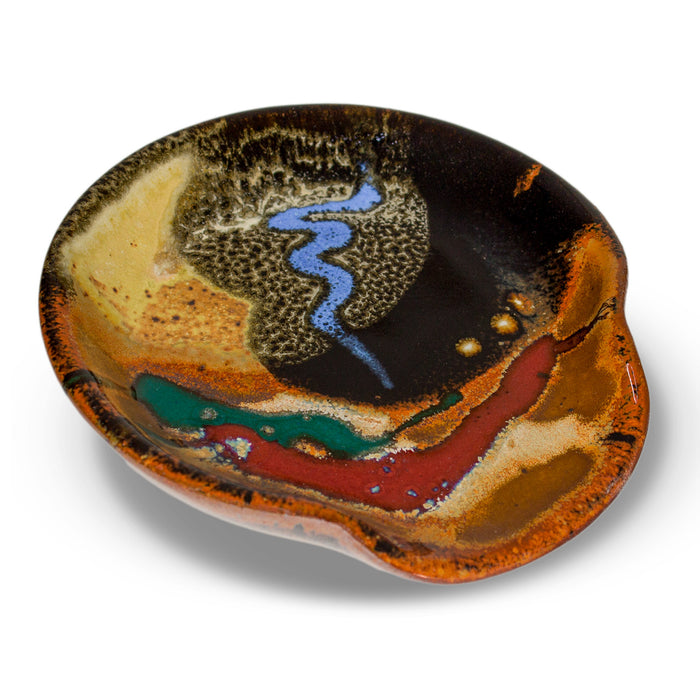 5 inch handmade pottery spoon rest in earth tone and red colors.  Hand made by Prairie Fire Pottery.  High-fired stoneware clay.  This is a 3/4 view of the product.