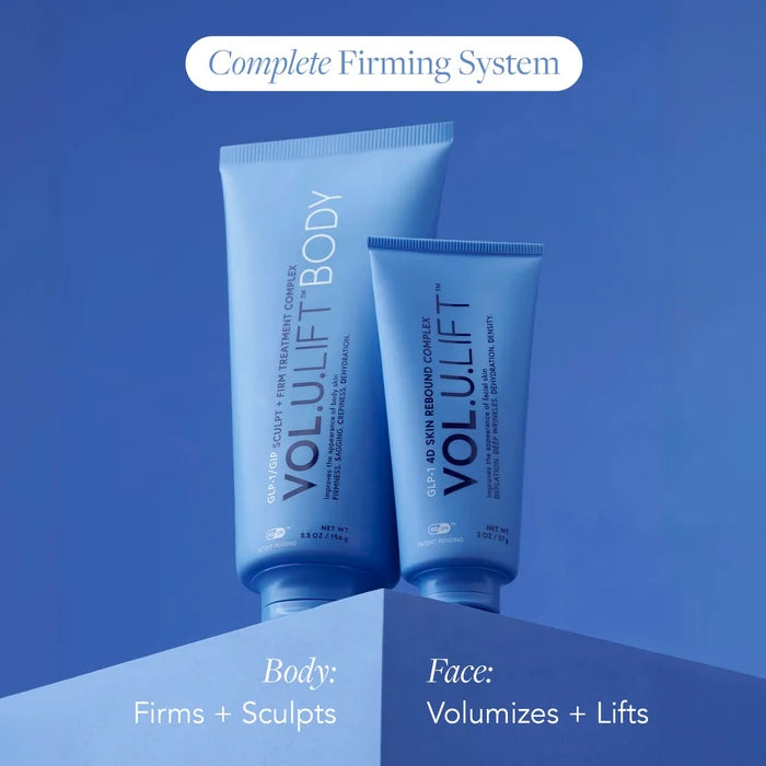 Two blue cosmetic tubes labeled VOLULIFT BODY and VOLULIFT FACE on a blue gradient background, with text reading 'Complete Firming System' and 'Body: Firms + Sculpts' and 'Face: Volumizes + Lifts'.